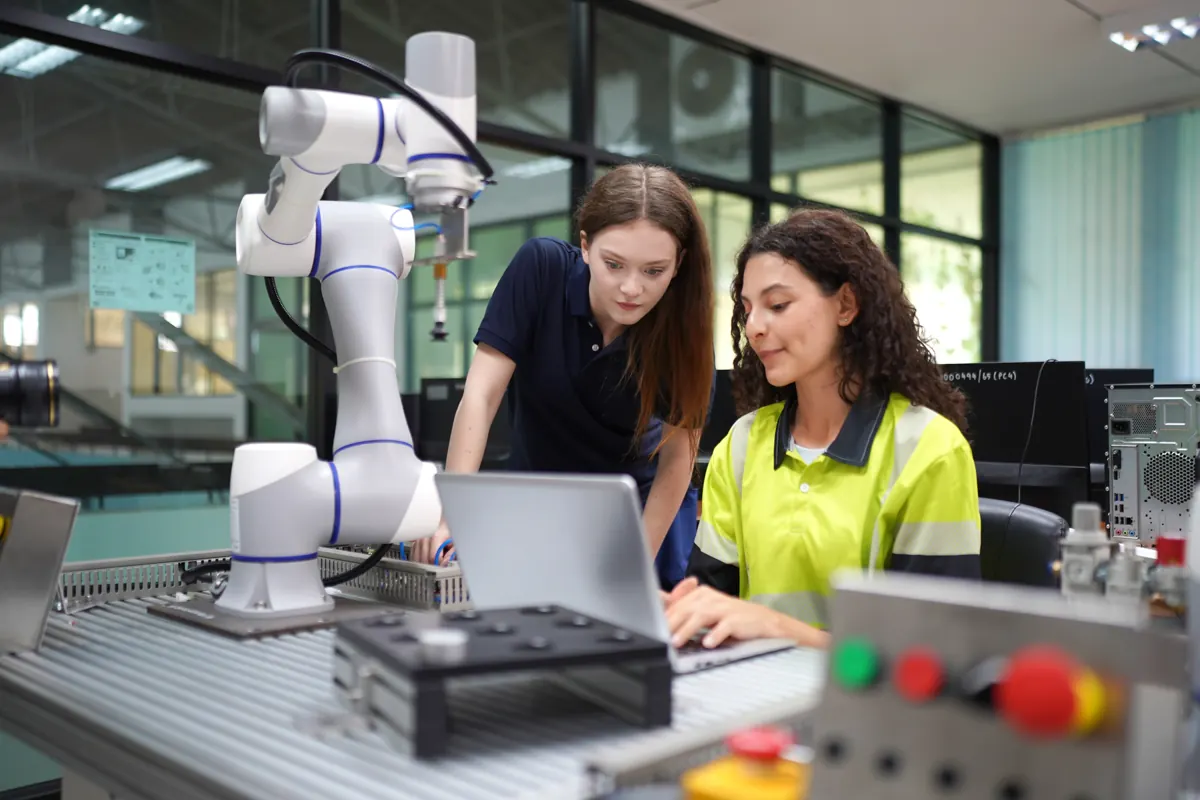 Students working with a robot arm in a lab